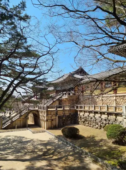 Stone bridge and temple buildings at Gyeongju Bulguksa Temple in spring