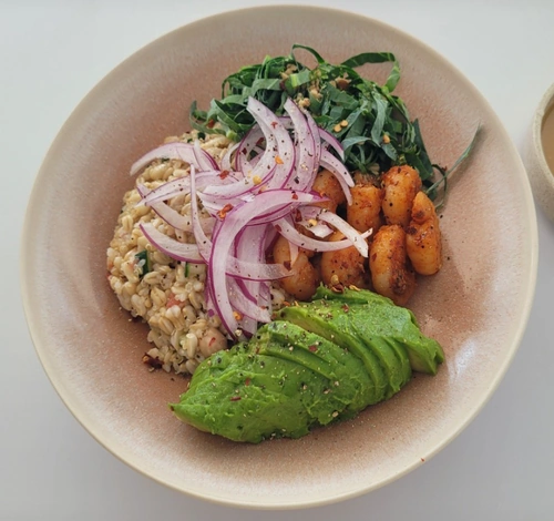 Oat bibimbap at Out of Order, a seongsu korean restaurant with avocado, red onion, and seasoned vegetables